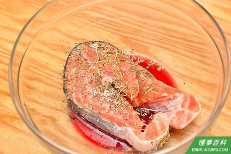 Step 2 在鱼肉上加入几调羹料酒。