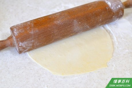 Step 9 在料理台上撒少许面粉,用擀面杖把面团一块块擀平。